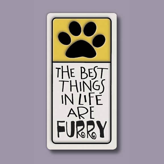 Ceramic magnet showing a black paw print on a yellow block above the text The Best Things In Life Are Furry