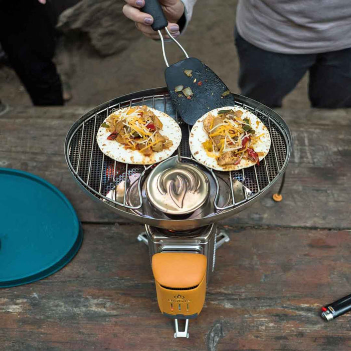 Lifestyle image of a meal being cooked on a Biolite CampStove portable grill
