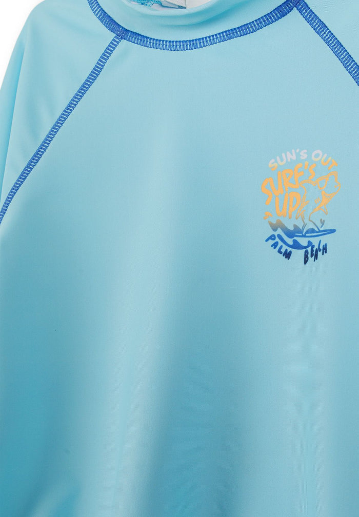 Detail of boys long sleeve rash vest in turquoise with logo print.