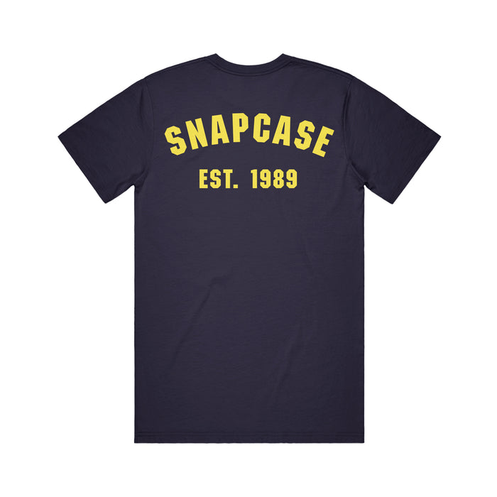A black Snapcase T-shirt featuring SNAPCASE in large yellow letters and EST. 1989 printed beneath it on the back.