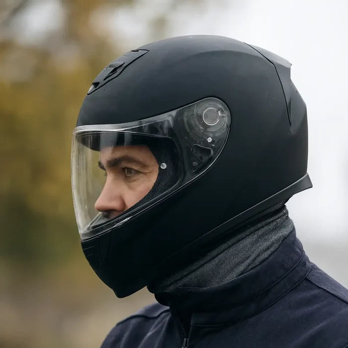 Man wearing a grey marl Sub Zero Factor 1 balaclava underneath their motorbike helmet with a blurred outdoor background