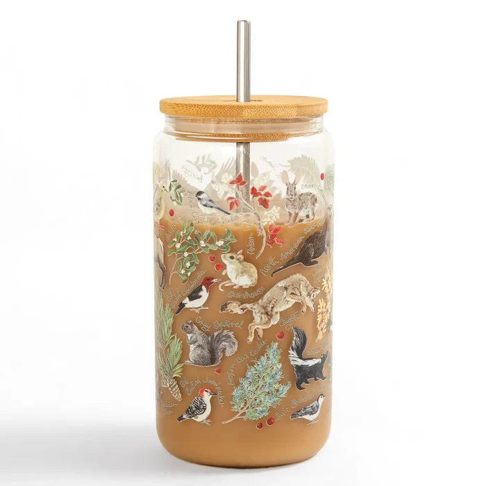 Flora and Fauna glass tumbler with bamboo lid and straw showing a brown beverage and nature illustrations