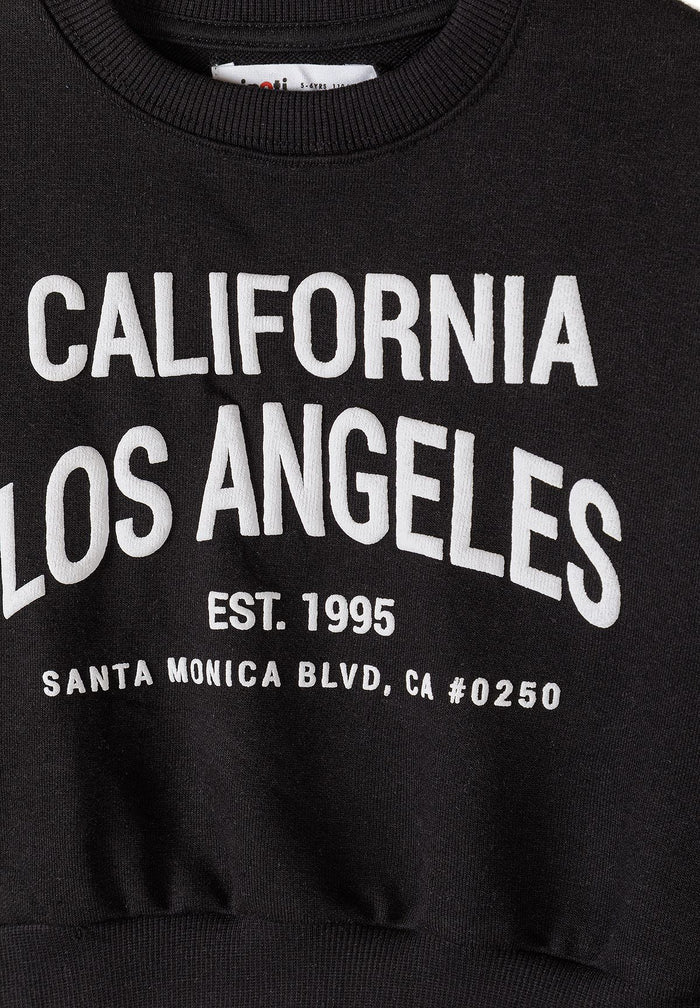 Detail of a black sweatshirt with white 'California Los Angeles' text.