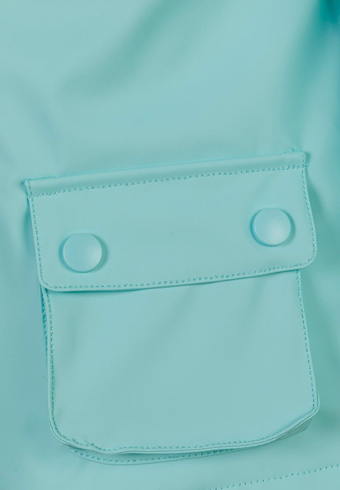 Detail of a mint waterproof jacket showing a snap pocket.