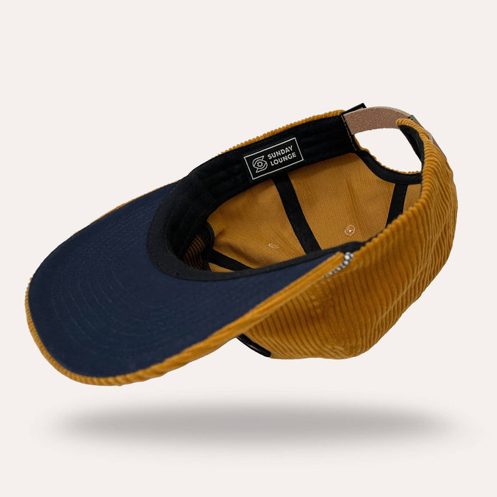 Interior view of mustard corduroy flatbrim hat with Sunday Lounge label
