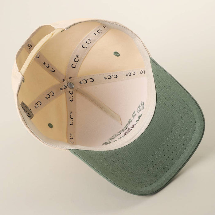 Inside view of a cream trucker hat with a green bill and C C logo tape along the crown