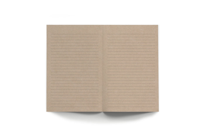 Open kraft layflat notebook with horizontal ruled lines on both pages.