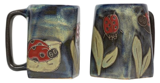 Square stoneware mug with a red ladybug design on a dark blue glaze and leaves