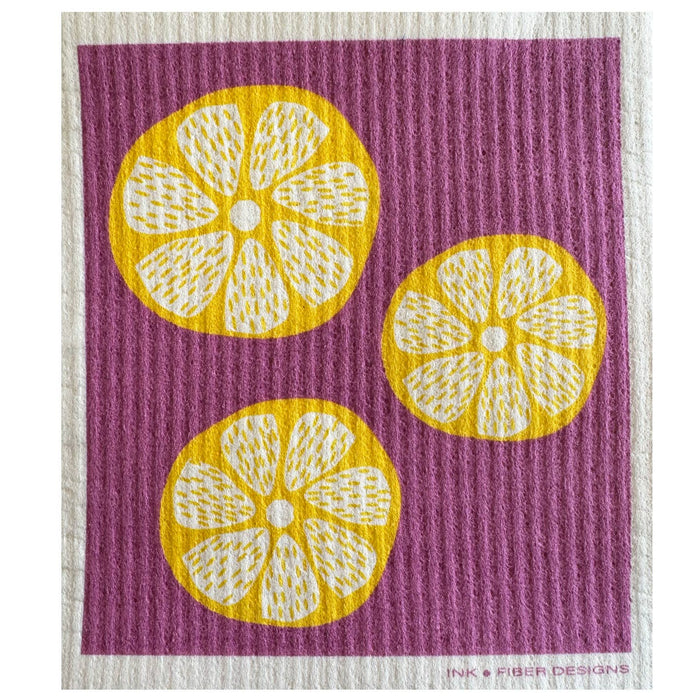 Lemon Slices Swedish dishcloth with yellow lemon rounds on a purple textured background