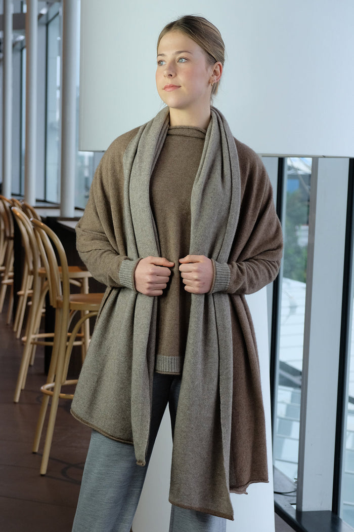 Woman wearing a long brown wrap in an indoor setting