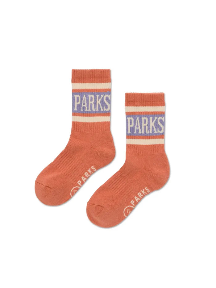 Orange crew socks with striped cuffs and PARKS on the cuff