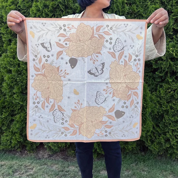 Peach butterfly and flowers bandana with large peach roses and butterflies displayed outdoors with a peach border