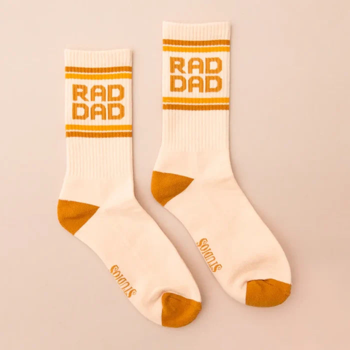 Pair of white ribbed crew socks with orange stripes and RAD DAD lettering