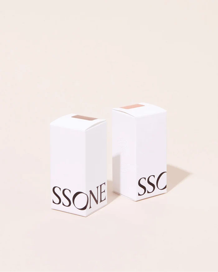 Two white packaging boxes with Ssone's branding on a beige background