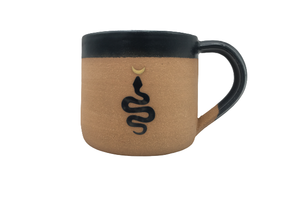 Snake and Moon wheel thrown mug with tan body black rim and handle and a black snake motif with a small crescent moon