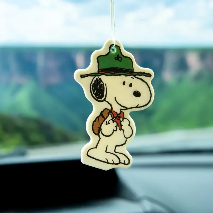Snoopy the Scout air freshener hanging from a string inside a car wearing a green hat