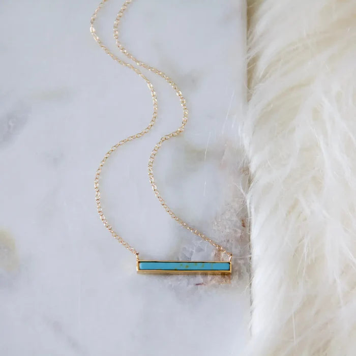 Gold chain necklace with a rectangular turquoise bar pendant