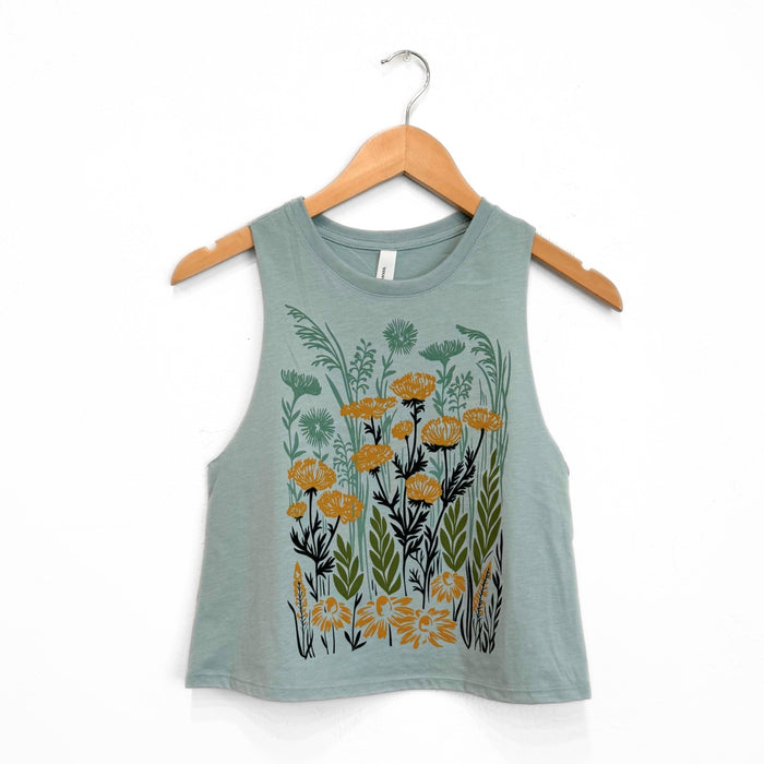 Pale blue green crop tank on a hanger with a large botanical print