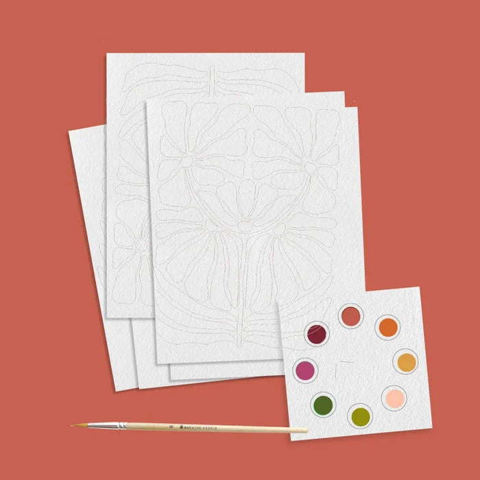 Stacked white cards show pale pencil line floral outlines ready for coloring.