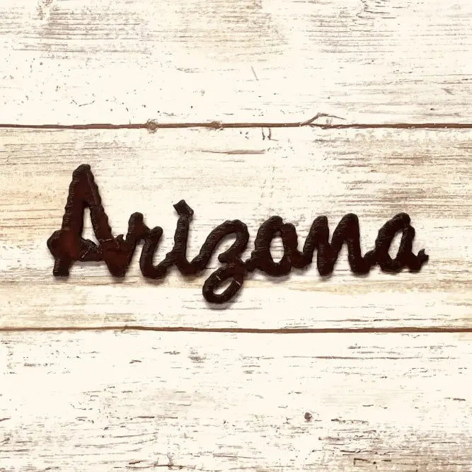 Rustic magnet spelling Arizona in script on distressed whitewashed wood