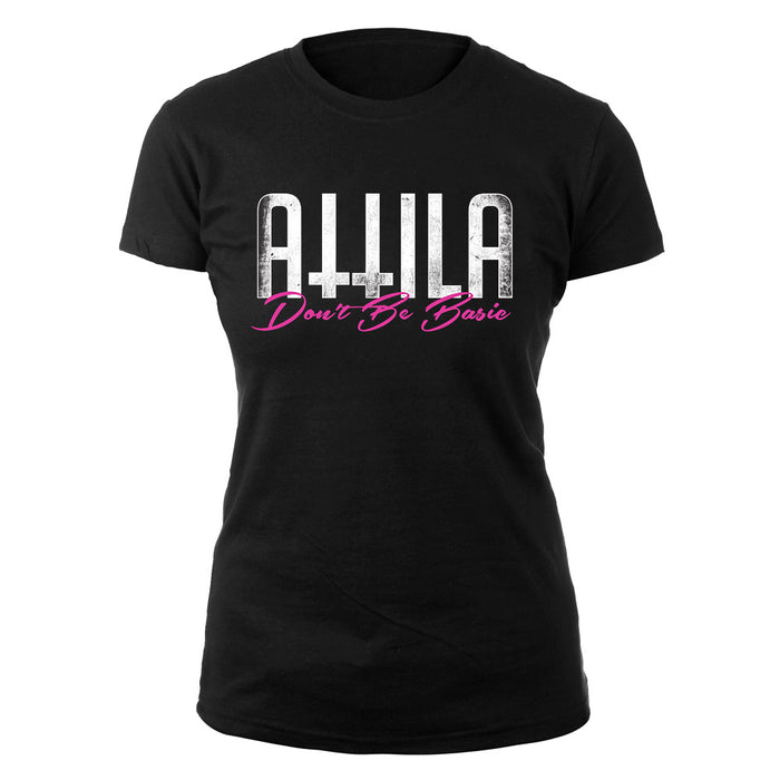 A black womens T-shirt by Attila with ATTILA in bold white letters above Dont Be Basic in pink cursive on the front.