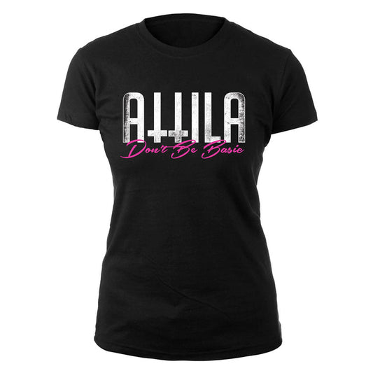 A black womens T-shirt by Attila with ATTILA in bold white letters above Dont Be Basic in pink cursive on the front.