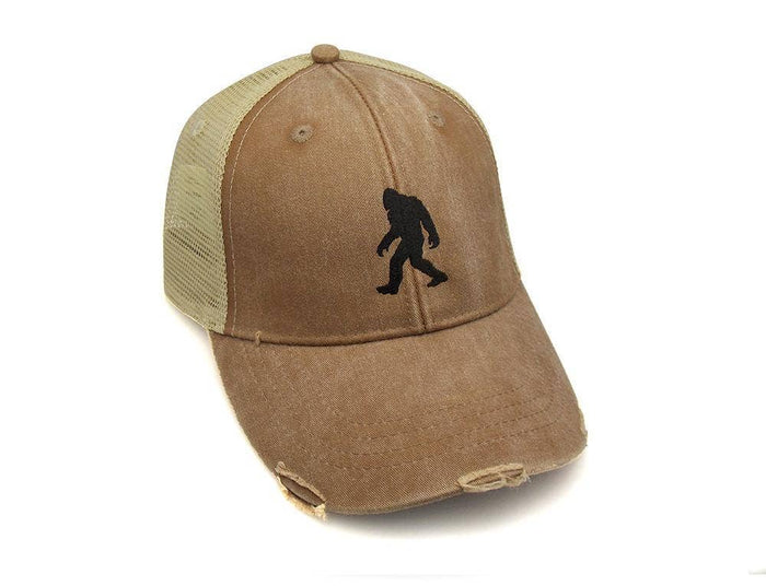 Brown front panel Bigfoot trucker hat with beige mesh back and a black silhouette plus distressed brim.