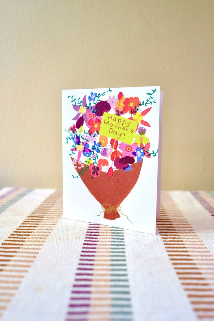 Vibrant bouquet illustration on a Mother's Day card with a yellow note reading Happy Mother's Day