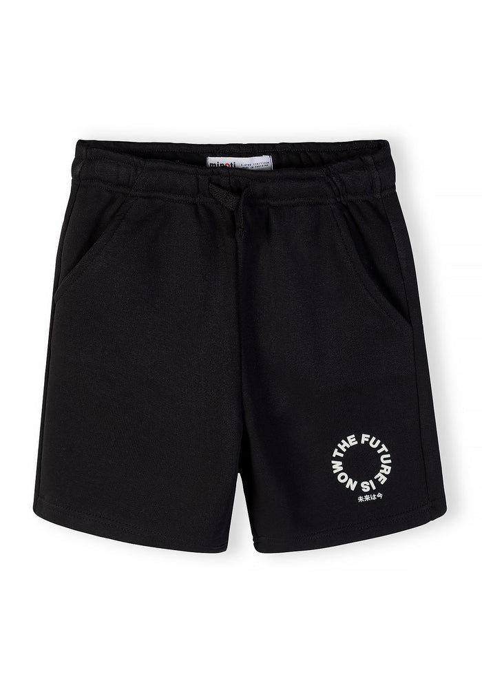 Detail of black shorts with elastic waistband and printed logo.
