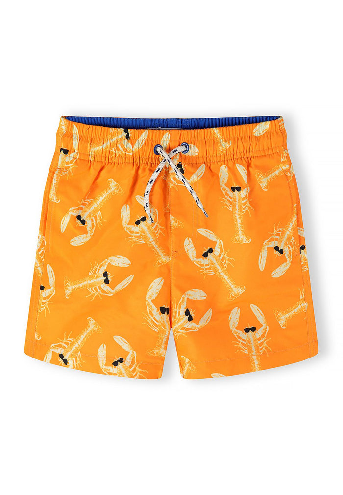 Boys quick dry swim shorts in orange with lobster print, front view.