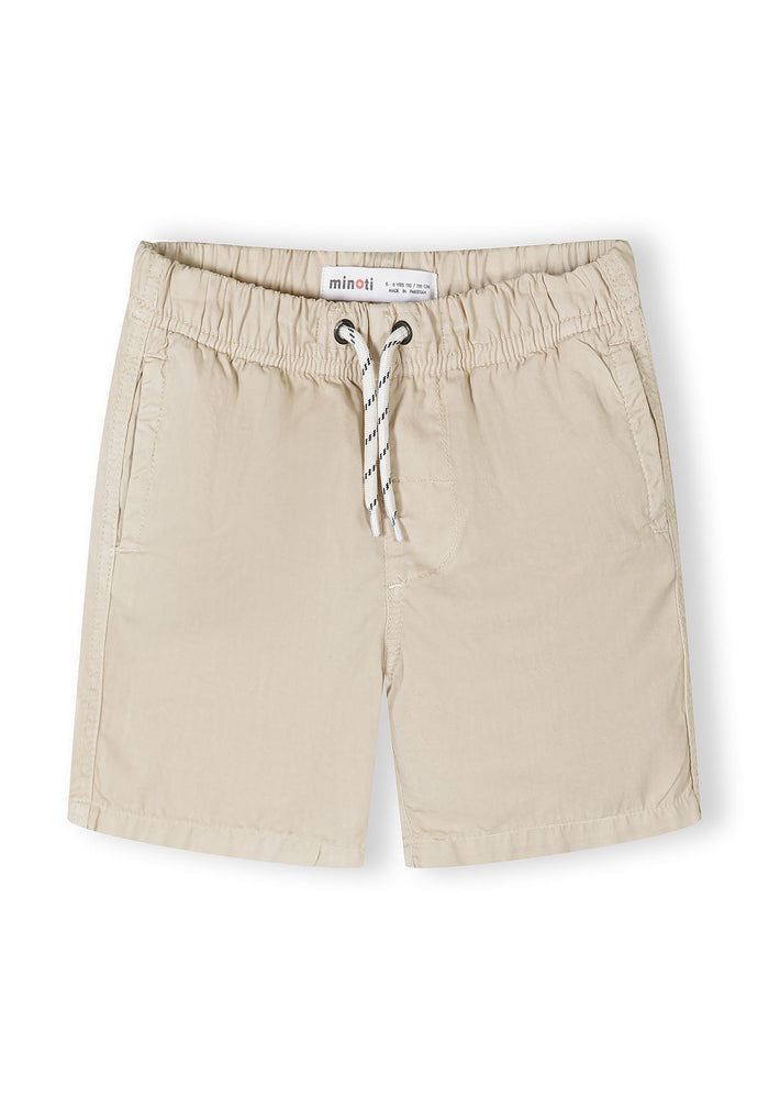 Detail of beige woven cotton shorts with elasticated waistband and side pockets.