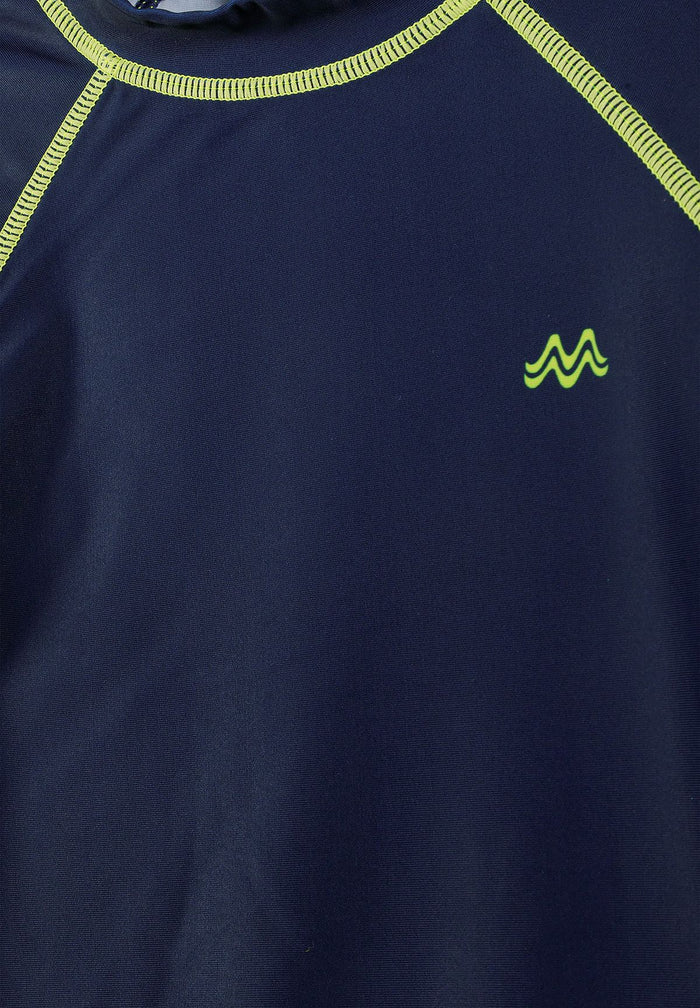 Close-up of a navy rash top with lime stitching and logo.