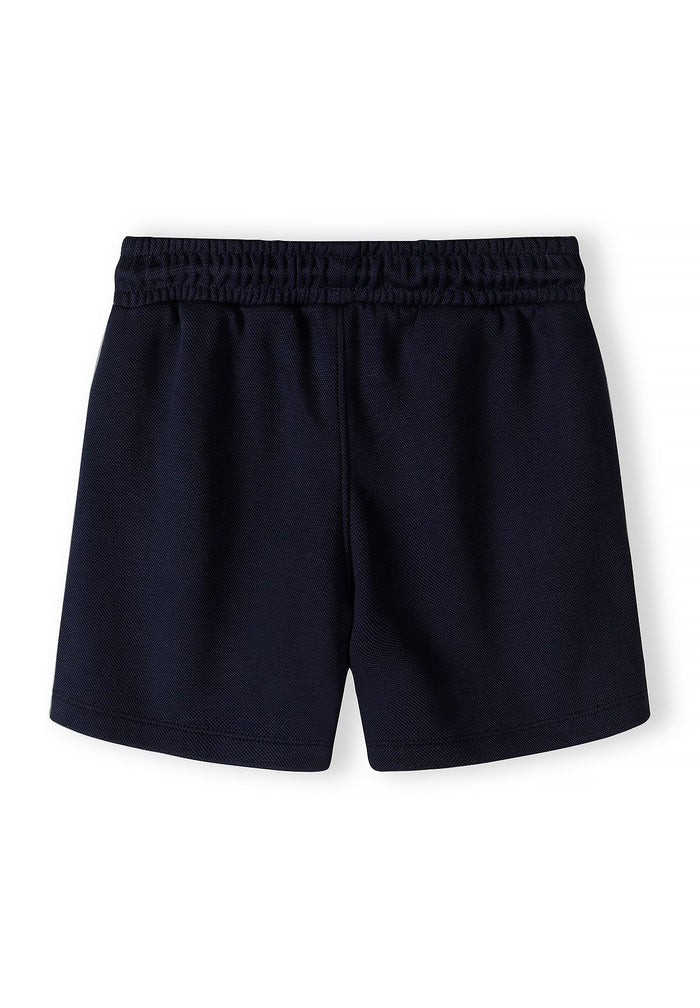 Boys navy shorts with elasticated waistband, back view.