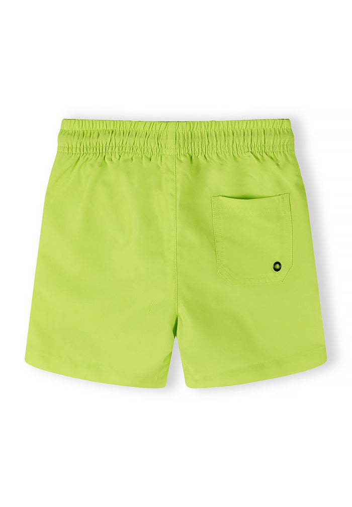Boys swimming shorts in lime, back view with elasticated waist and side pocket.