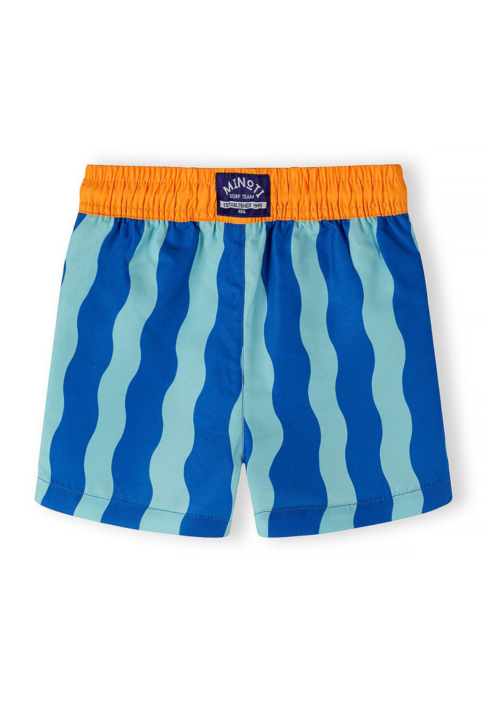 Boys swimming shorts in blue and aqua wavy pattern, front view with elastic waistband.