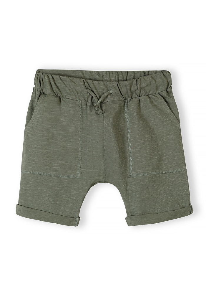 Boys' cotton jersey shorts in green, front view with adjustable drawstring waistband and side pockets.