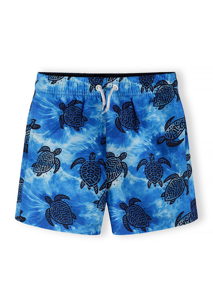Boys' blue swimming shorts with turtle motif, front view.