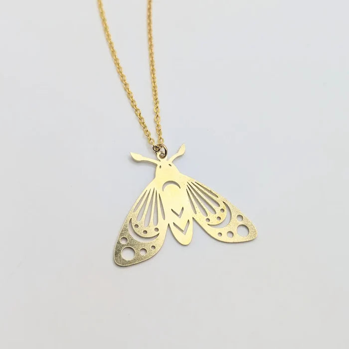 Gold brass moth pendant necklace with intricate cutout wings on a thin chain