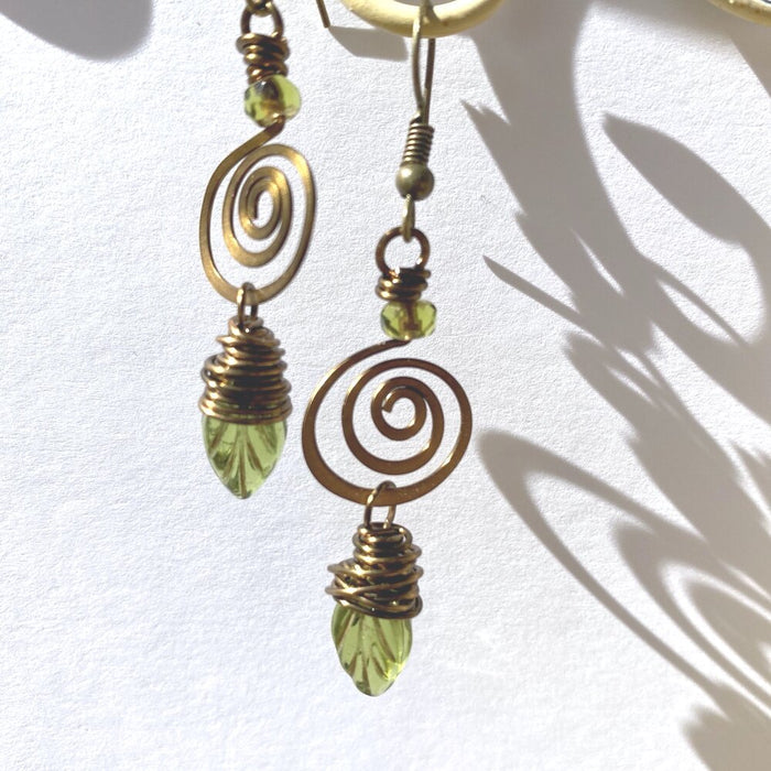 Dangling brass spiral olive leaf earrings with wrapped green teardrop beads
