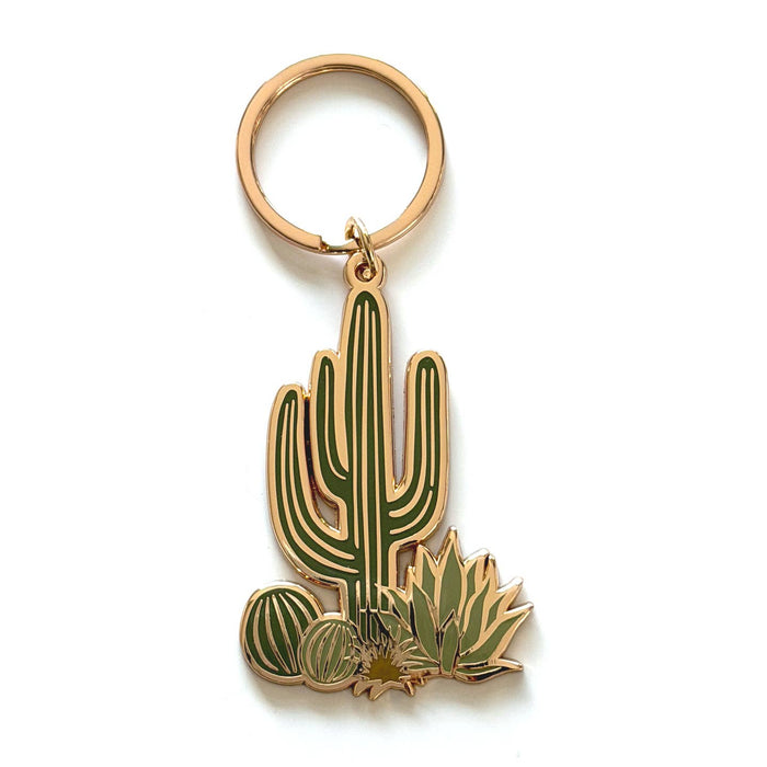 Cacti Cluster keychain featuring a tall central cactus and surrounding cacti with gold outlines and white flowers
