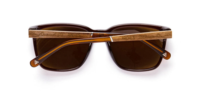 Top-down view of CAMP Crag Sunglasses Arches Edition with a wooden crossbar across the lenses and Arches engraving