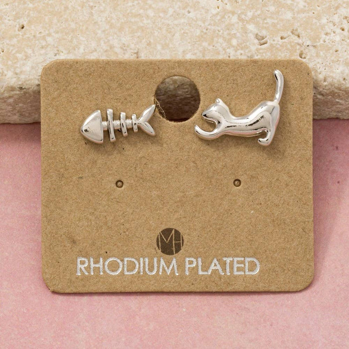 Cat and fish stud earrings in rhodium plated finish on a brown display card