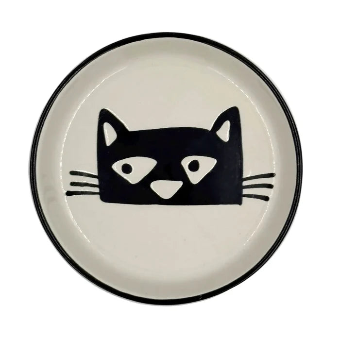 Round white coaster with a black stylized cat face design