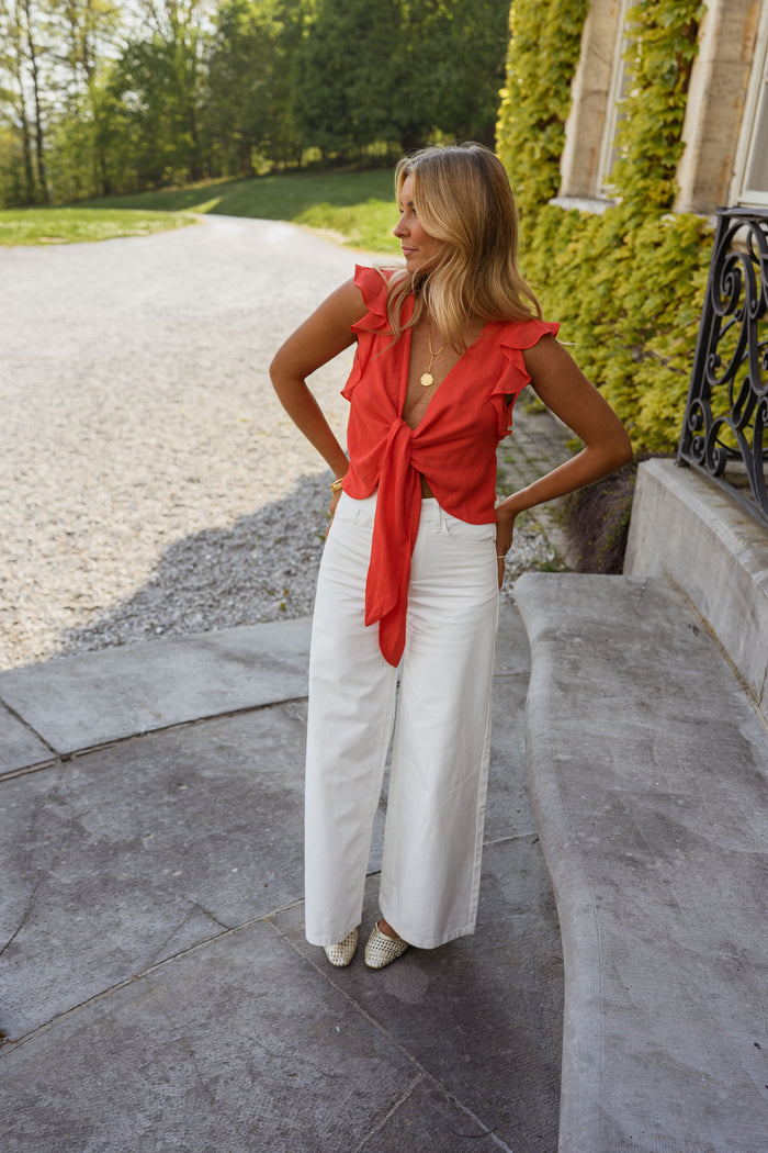 Coral Beth top showing V-neck and ruffle trim