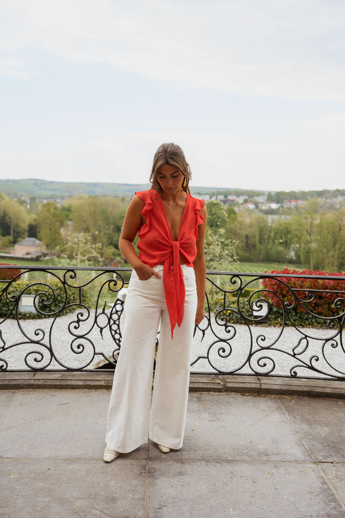 Coral Beth top styled with white jeans