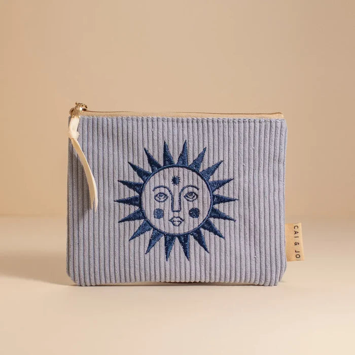 Light blue corduroy small pouch with a dark blue embroidered sun design and a zipper closure