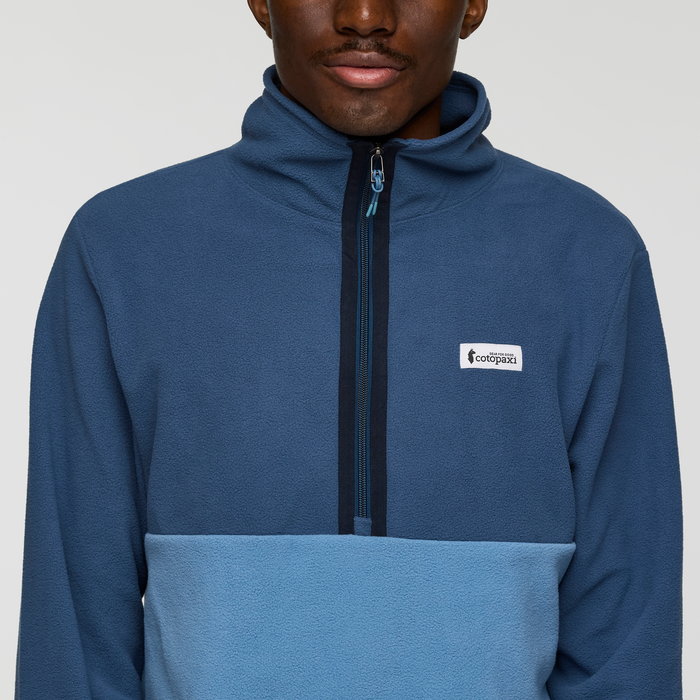 Front view of Cotopaxi Amado fleece pullover in blue with zip front and small logo patch on the left chest