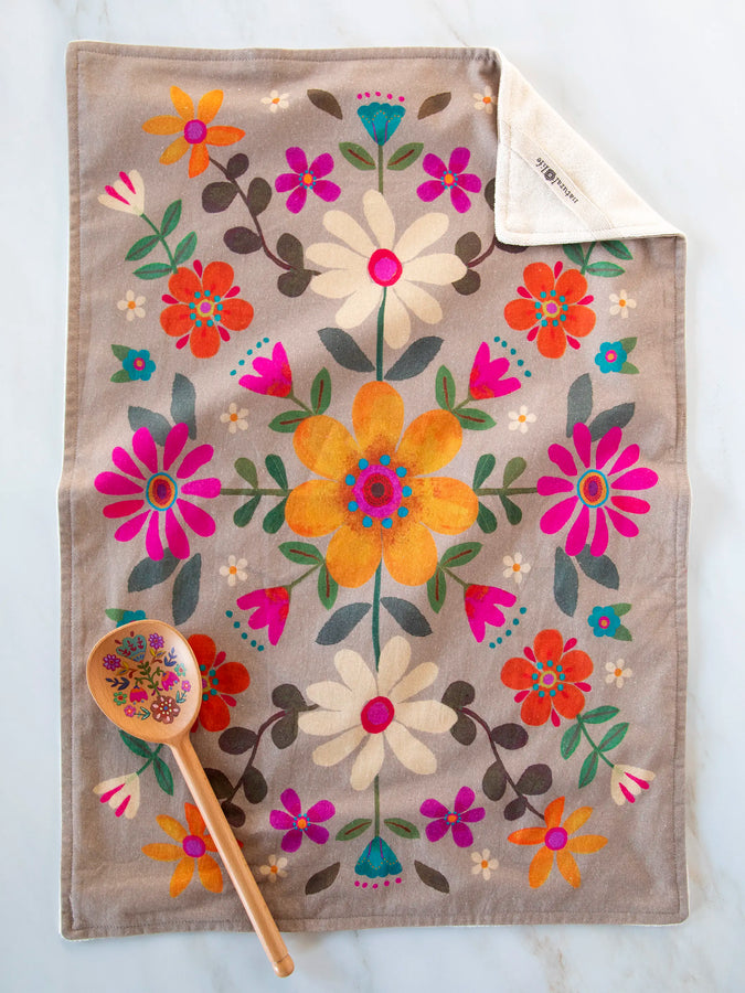 Taupe floral cotton dish towel spread flat with a colorful bouquet print and a wooden spoon