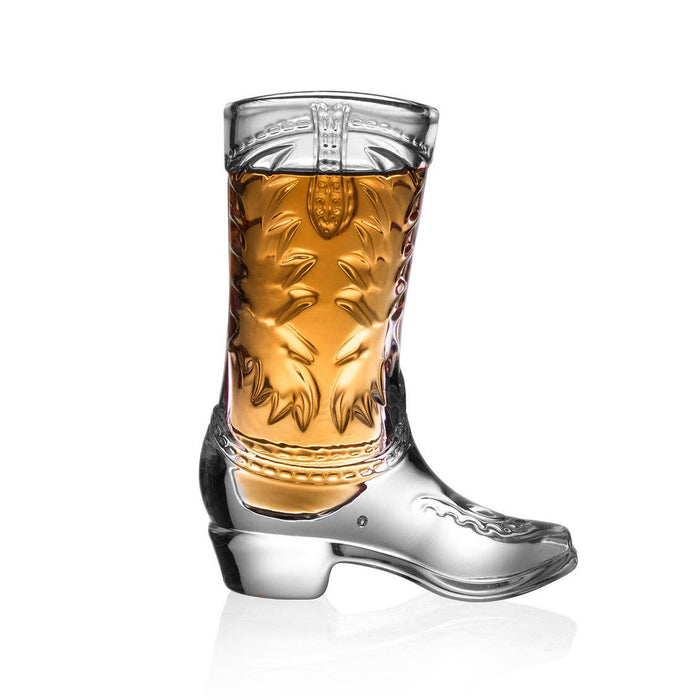 Cowboy boot shaped shot glass filled with amber liquid