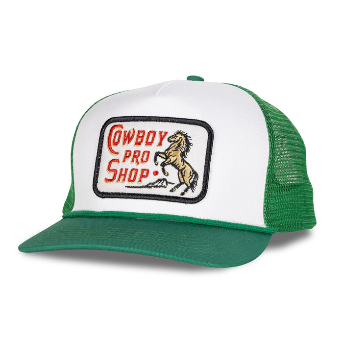 Close up of white front panel and green mesh Cowboy Pro Shop trucker hat with patch and horse graphic.